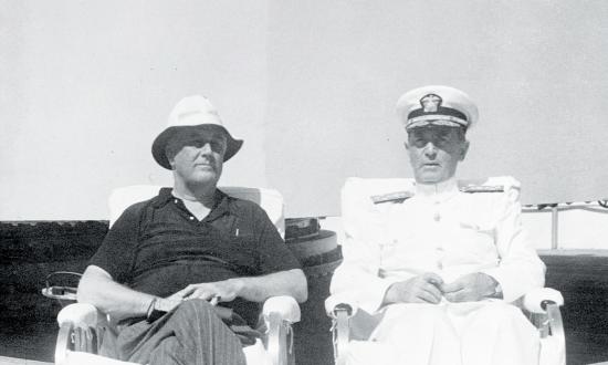 President Franklin Roosevelt relaxes with Chief of Naval Operations Admiral William Leahy on board the heavy cruiser USS  Houston (CA-30).